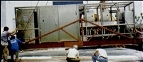 Machinery being positioned with wooden skid for vacuum packing and casing